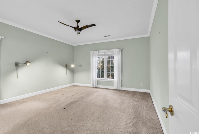 carpeted empty room with crown molding and ceiling fan