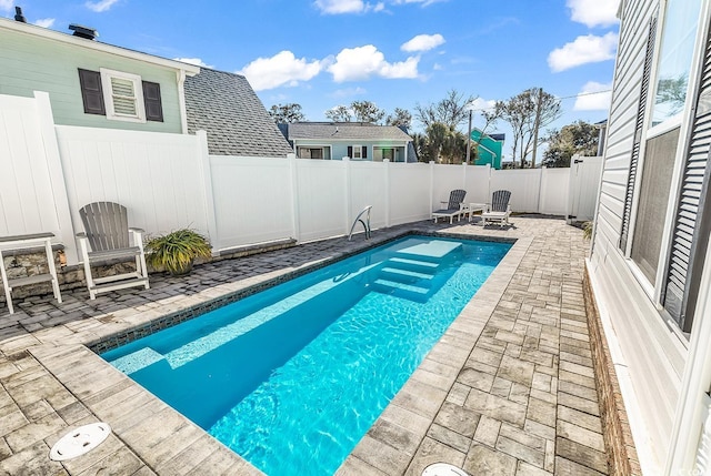 view of pool with an outdoor fire pit and a patio