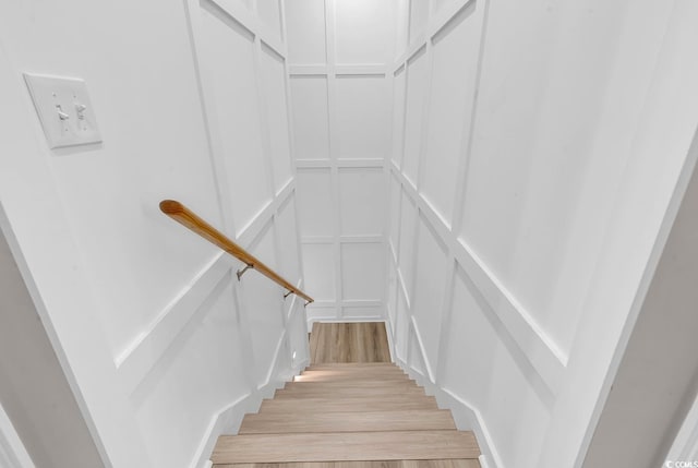 staircase with hardwood / wood-style flooring