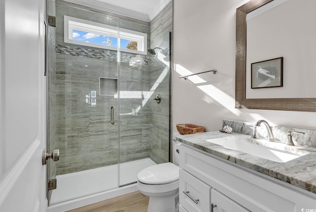 bathroom with vanity, toilet, a shower with shower door, and wood-type flooring