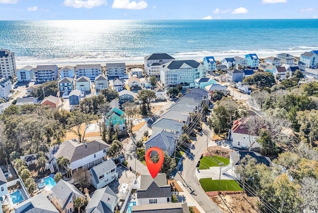 drone / aerial view with a beach view and a water view