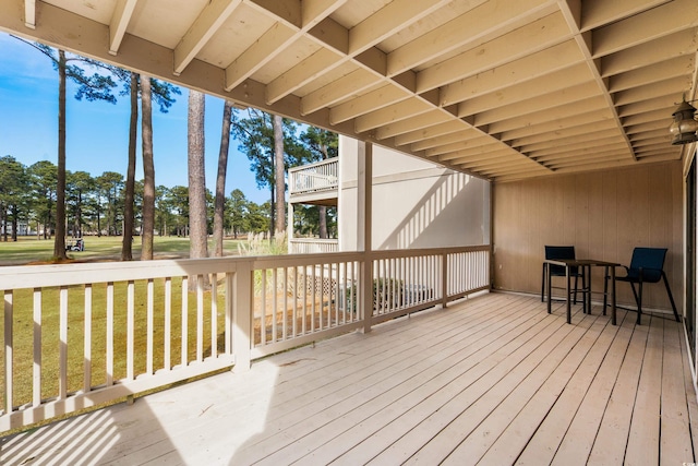 wooden deck with a lawn