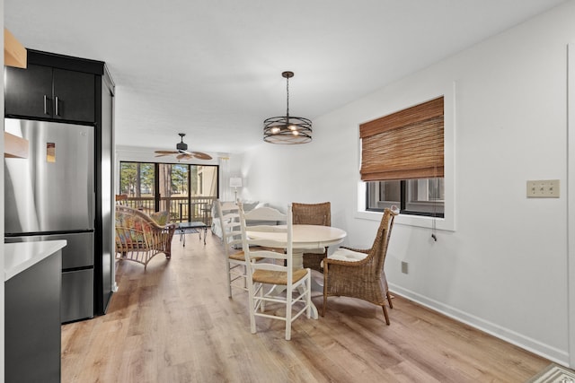 dining room with ceiling fan and light hardwood / wood-style flooring