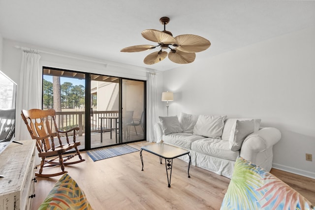 living room with ceiling fan and light wood-type flooring