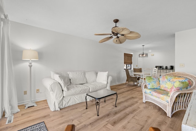 living room with ceiling fan and light hardwood / wood-style floors