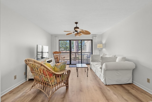 living room featuring ceiling fan and light wood-type flooring