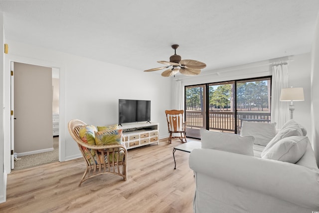 living room featuring ceiling fan and light wood-type flooring