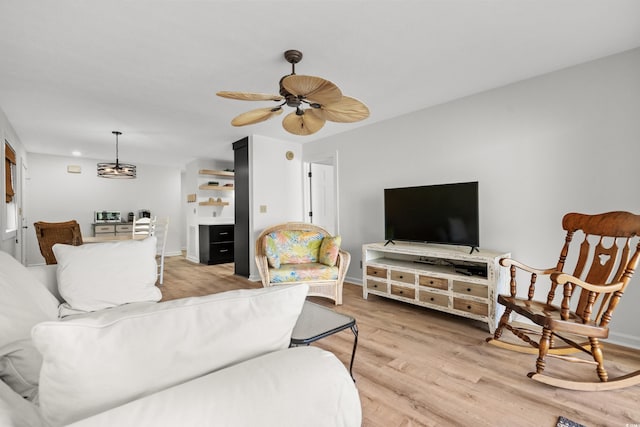 living room with ceiling fan and light hardwood / wood-style floors