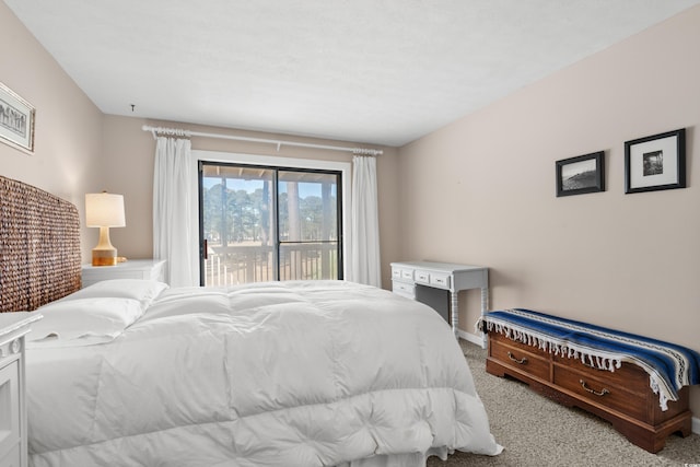 bedroom featuring access to exterior and light colored carpet