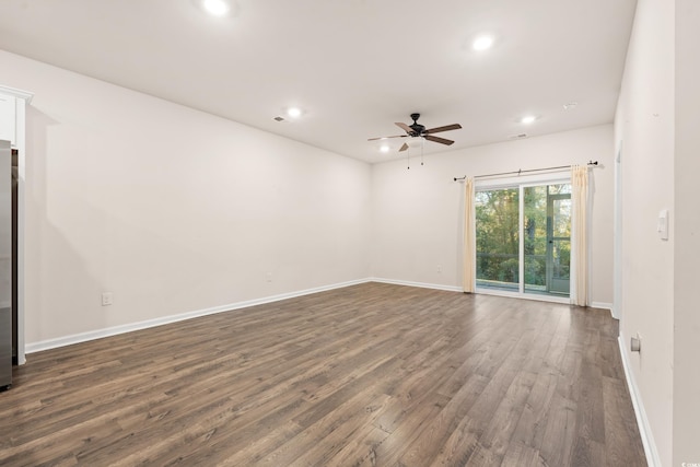 spare room featuring ceiling fan and dark hardwood / wood-style floors