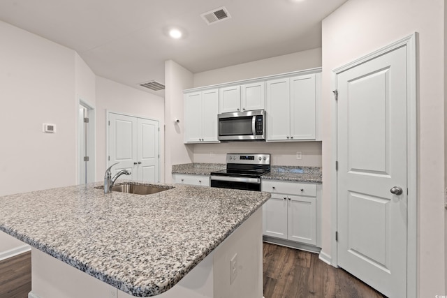 kitchen with white cabinetry, sink, a center island with sink, and appliances with stainless steel finishes