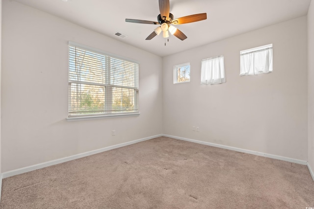 spare room featuring ceiling fan and light colored carpet