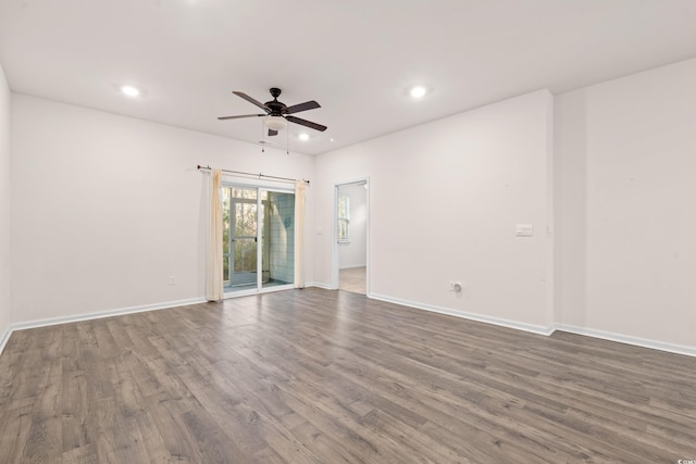 unfurnished room with dark wood-type flooring and ceiling fan