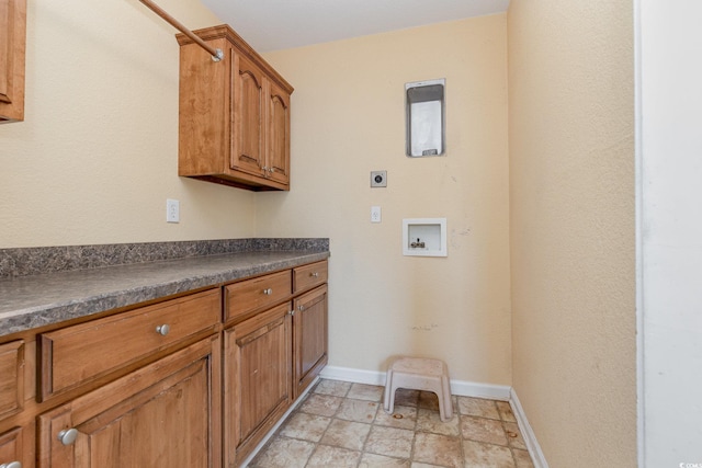 laundry area with cabinets, electric dryer hookup, and hookup for a washing machine