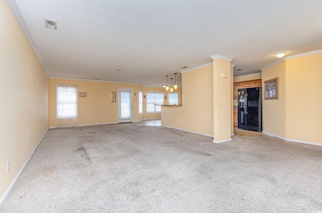 unfurnished living room featuring crown molding, light carpet, and a textured ceiling