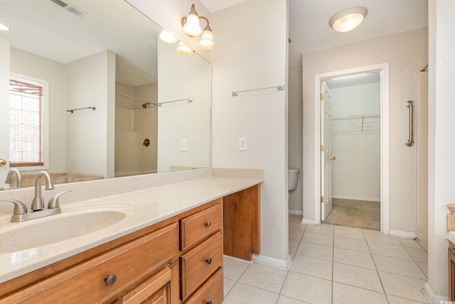 bathroom featuring vanity, tile patterned floors, and walk in shower