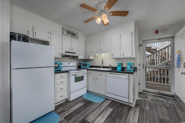 kitchen with dark hardwood / wood-style floors, sink, white cabinets, and white appliances