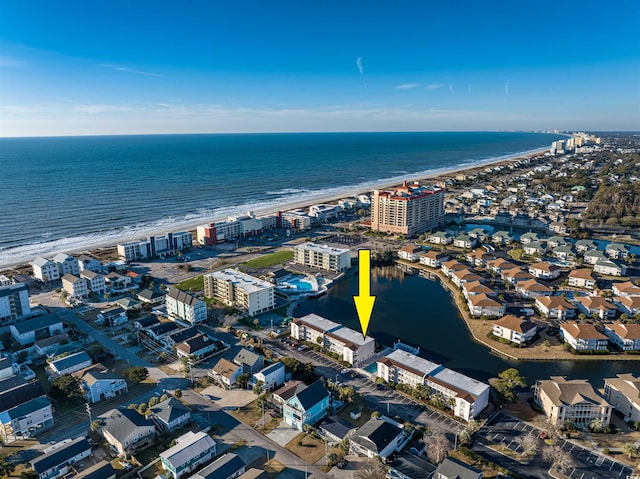 birds eye view of property with a view of the beach and a water view