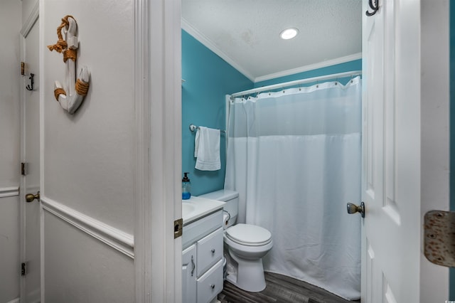 bathroom with toilet, crown molding, a textured ceiling, vanity, and hardwood / wood-style floors