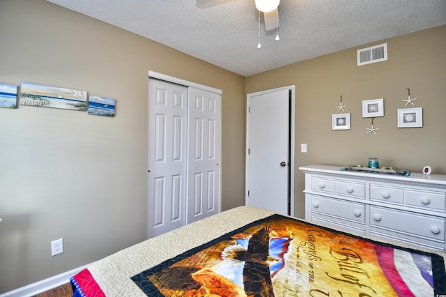 2225 Essex Dr Unit F, Surfside Beach, SC 29575 - bedroom with a closet, a textured ceiling, visible vents, baseboards, and ceiling fan