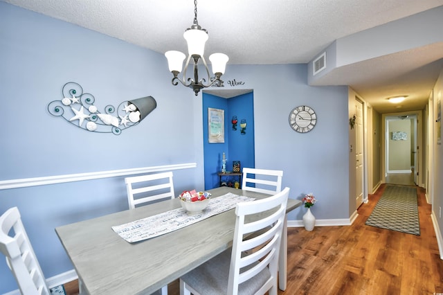 2225 Essex Dr Unit F, Surfside Beach, SC 29575 - dining space with an inviting chandelier, visible vents, a textured ceiling, and wood finished floors