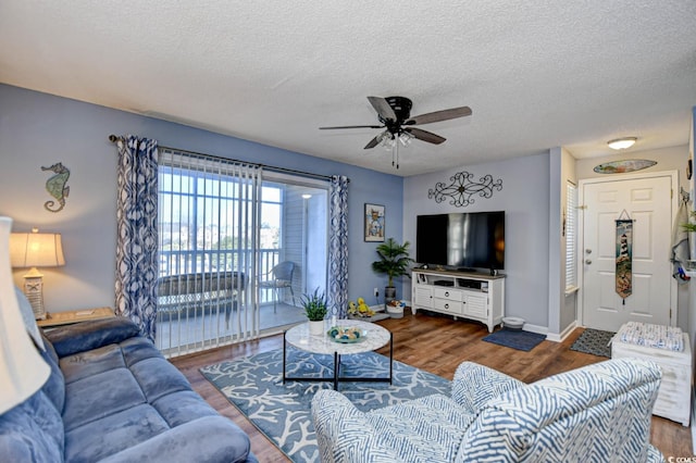 2225 Essex Dr Unit F, Surfside Beach, SC 29575 - living room with a textured ceiling, baseboards, wood finished floors, and a ceiling fan