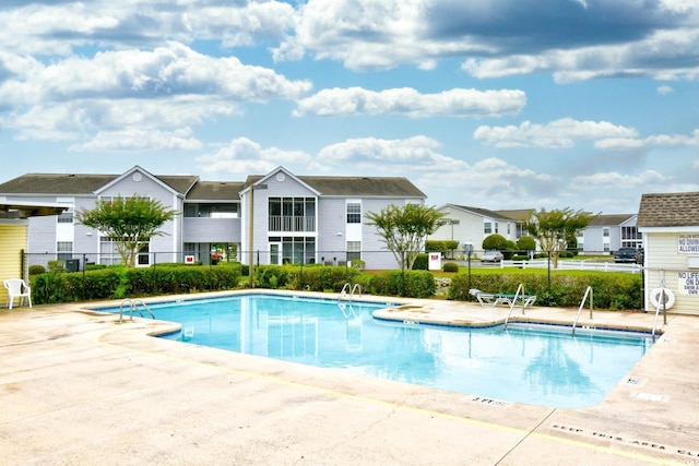 2225 Essex Dr Unit F, Surfside Beach, SC 29575 - pool with fence, a patio, and a residential view