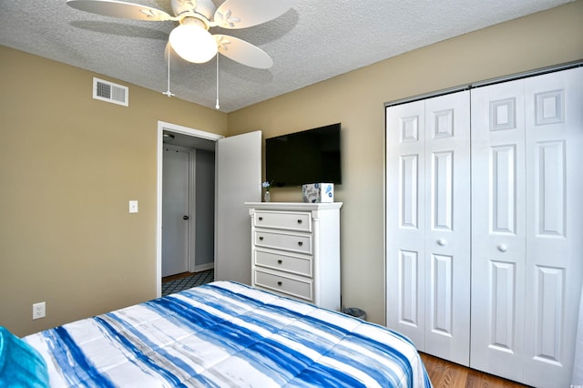 2225 Essex Dr Unit F, Surfside Beach, SC 29575 - bedroom with a textured ceiling, a closet, a ceiling fan, and visible vents