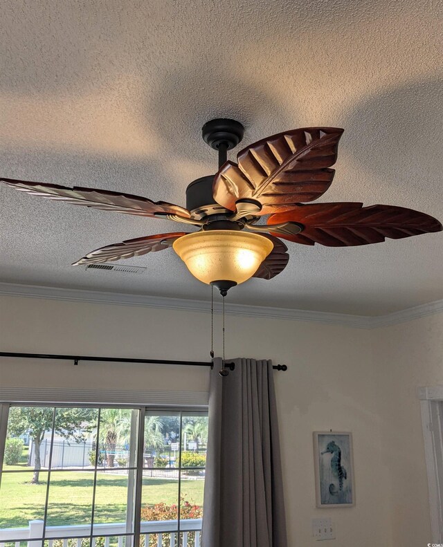 details with ornamental molding, ceiling fan, and a textured ceiling