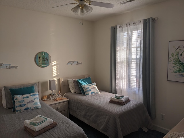 bedroom featuring ceiling fan and a textured ceiling