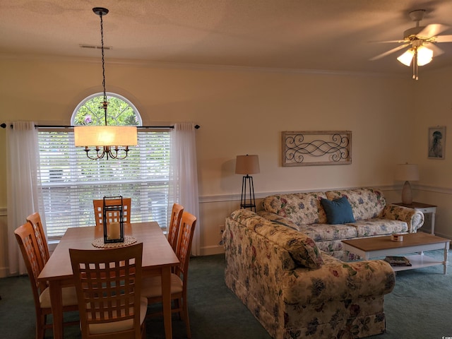 dining space featuring crown molding, dark carpet, and ceiling fan