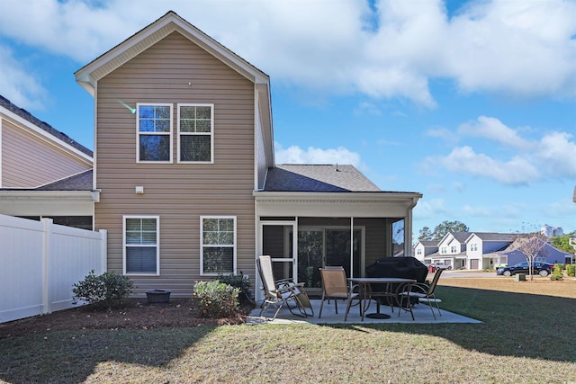 back of house featuring a yard and a patio area