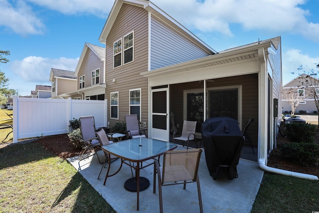 back of property featuring a lawn and a patio