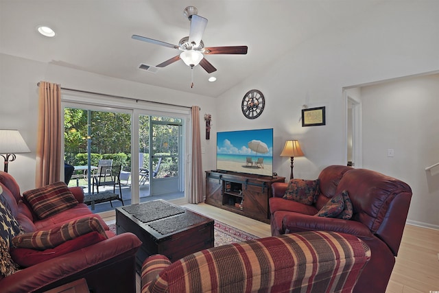 living room featuring lofted ceiling, ceiling fan, and light hardwood / wood-style flooring