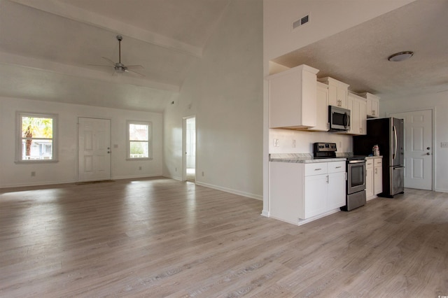 104 Willow Ridge Rd, Myrtle Beach, SC 29588 - kitchen with stainless steel appliances, open floor plan, ceiling fan, baseboards, and high vaulted ceiling