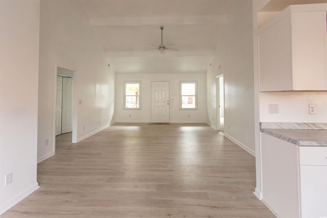 entrance foyer featuring beam ceiling, high vaulted ceiling, ceiling fan, and light hardwood / wood-style flooring