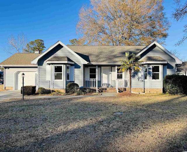 single story home with a garage, a porch, and a front yard