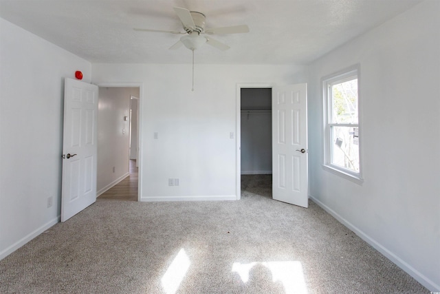 unfurnished bedroom with ceiling fan and carpet flooring