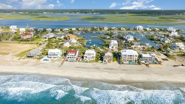 birds eye view of property with a water view and a view of the beach