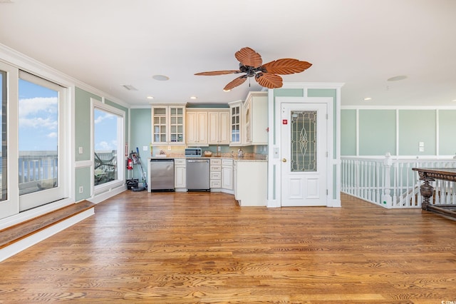 kitchen with glass insert cabinets, light wood-type flooring, crown molding, and stainless steel dishwasher