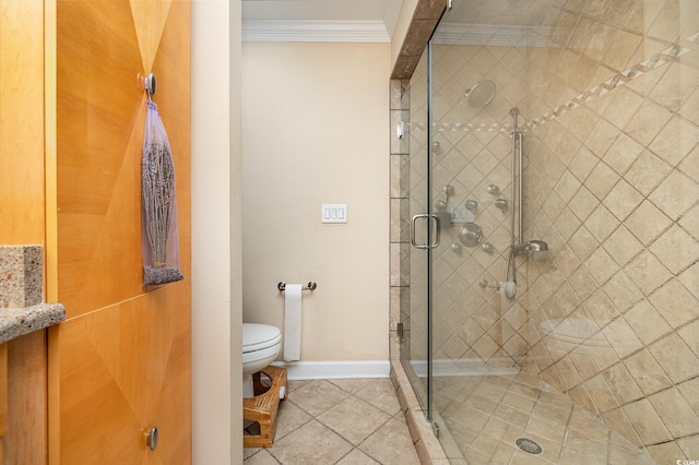 full bath featuring toilet, baseboards, ornamental molding, tile patterned floors, and a stall shower