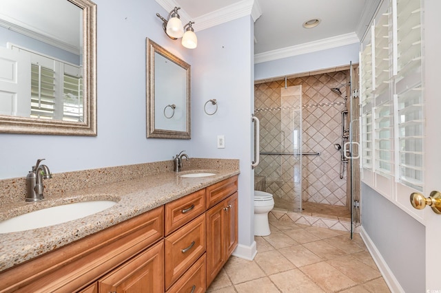 full bath featuring double vanity, baseboards, ornamental molding, and a sink