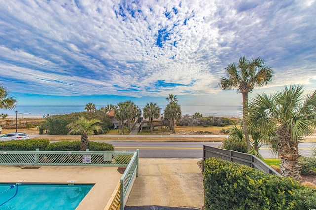 view of swimming pool featuring a water view