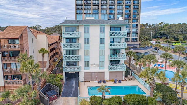 view of building exterior featuring a community pool