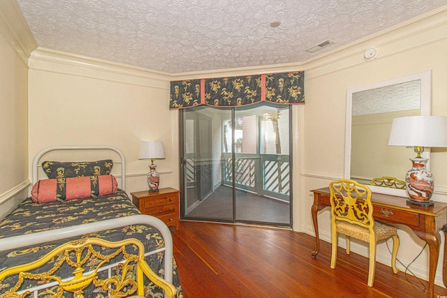 bedroom with ornamental molding, access to outside, a textured ceiling, and dark hardwood / wood-style flooring