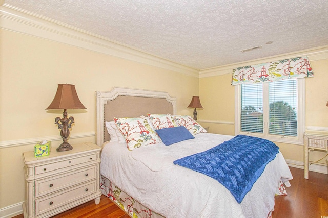 bedroom with crown molding, dark hardwood / wood-style floors, and a textured ceiling