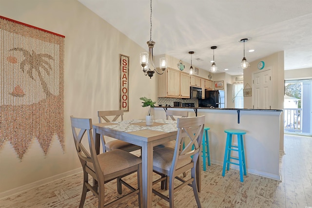 dining room with an inviting chandelier and light hardwood / wood-style flooring