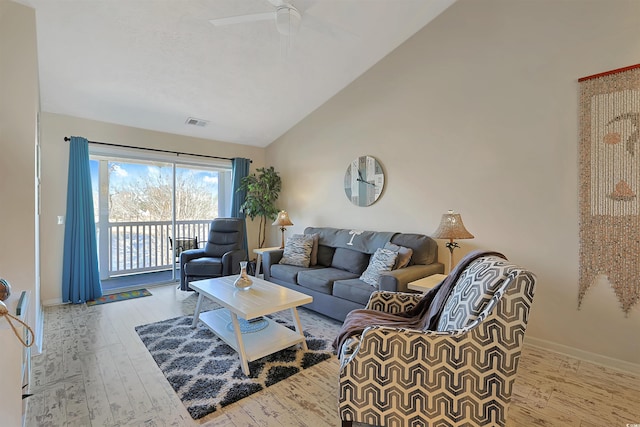 living room with high vaulted ceiling, light hardwood / wood-style floors, and ceiling fan