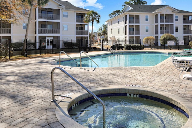 view of swimming pool featuring a hot tub