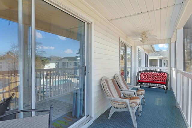 sunroom featuring ceiling fan